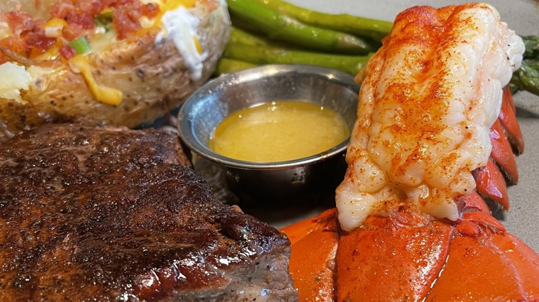 Outback Steakhouse steak, lobster, asparagus, and potatoes with butter