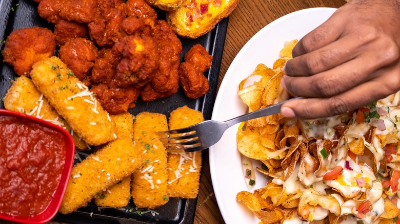 TGI Fridays appetizers spread with mozzarella sticks, wings, and nachos