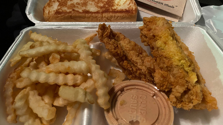 Raising Cane's boxed meal with Cane's Sauce in front