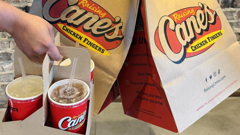 Raising Cane's takeout bags with drinks