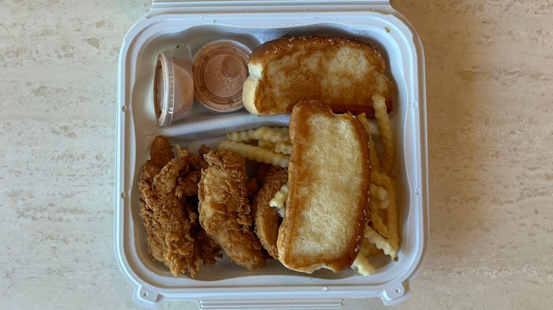Raising Cane's takeout box with Texas toast, chicken fingers, and fries
