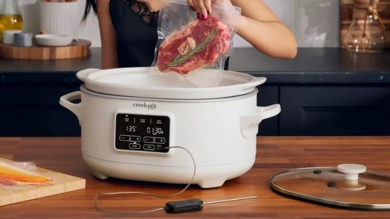 Woman preparing to make a meat dish with thermometer on crockpot