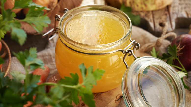 Close up of chicken broth in a glass jar