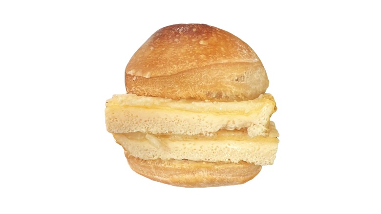 Frankie's egg and cheese sandwich on a roll on a white background