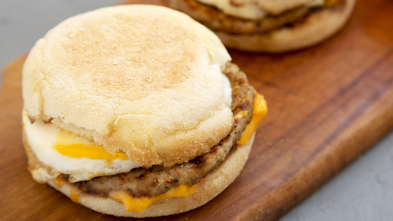 Close-up photo of a breakfast sandwich with sausage, egg, and cheese on an English muffin