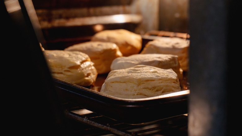 Interior shot of an oven with flaky biscuits baking