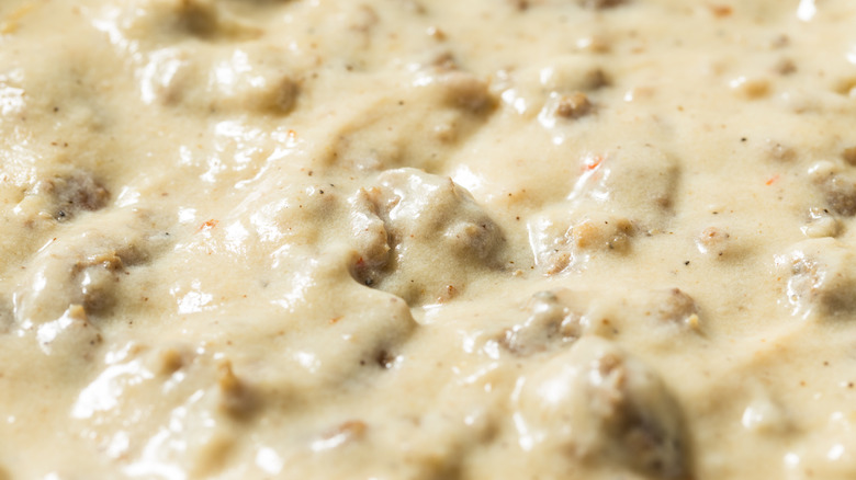 A close-up of white sausage gravy