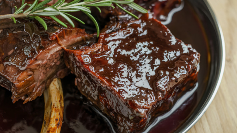 Close-up of braised ribs with rosemary
