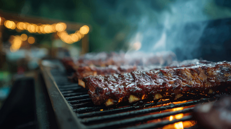 Ribs finishing on the grill with sauce