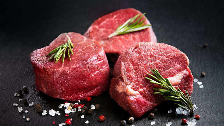 Three raw filets coming to room temp with rosemary and salt