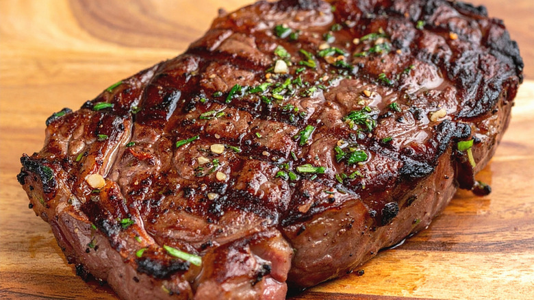 Grilled ribeye resting on a board
