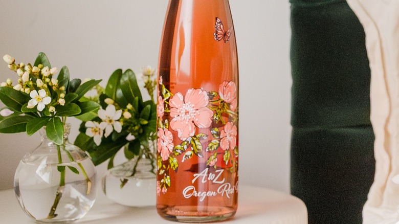 Bottle of A to Z rose with flowers.