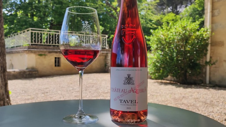 Bottle and glass of Chateau d'Aqueria Tavel Rose