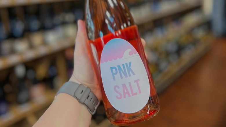 Person holding OVUM Wines PNK Salt bottle