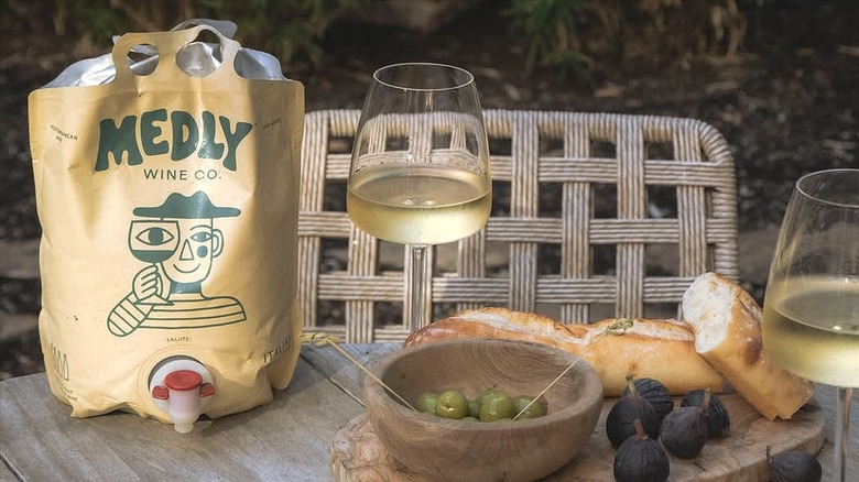 Bag and glass of Medly white wine with olives and figs