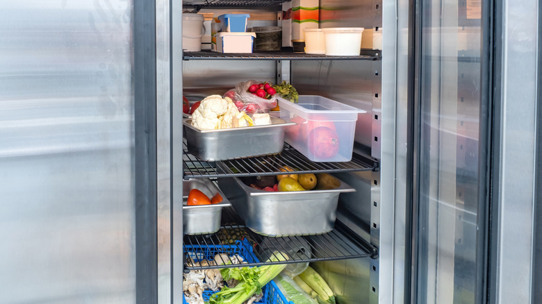 Restaurant refrigerator, open with produce inside