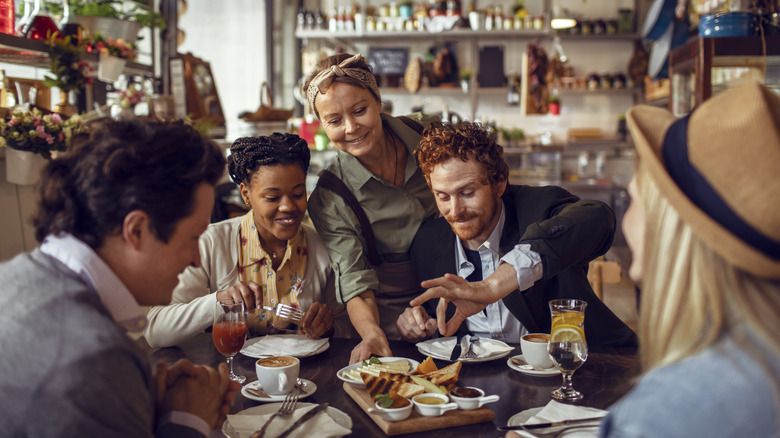 Waiter delivering food to table