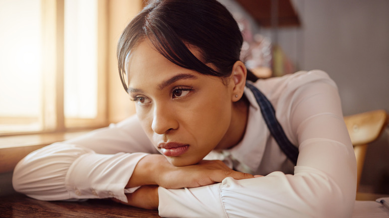 Bored waiter leaning on table