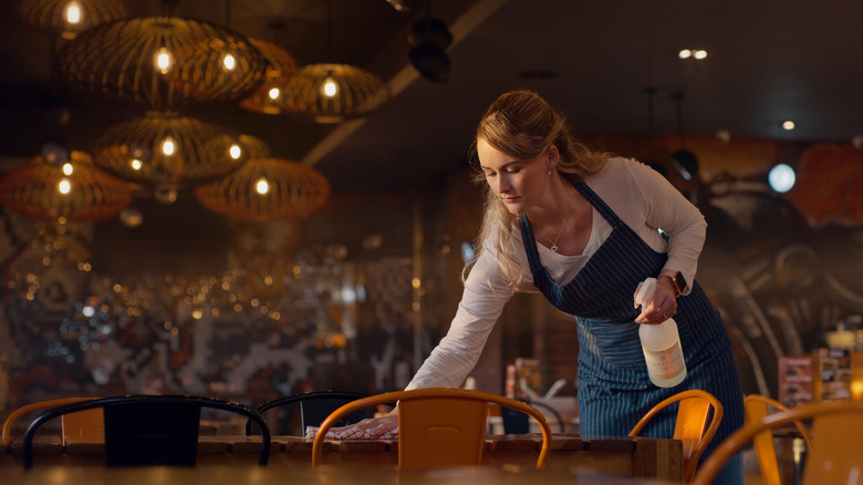 Waitress cleaning table