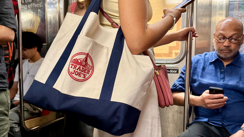 Woman with Trader Joe's tote bag on subway