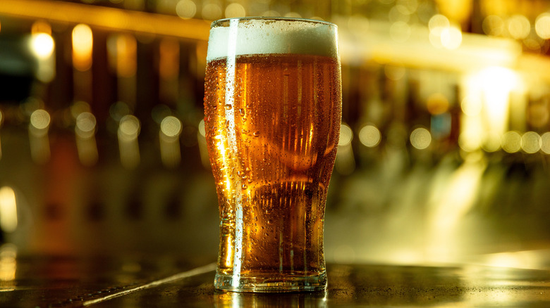 Frothy pint of beer in a nondescript pub