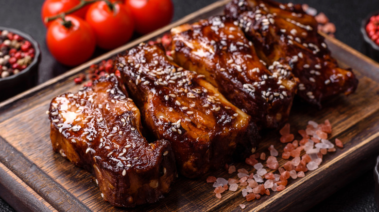 Four grilled steaks on cutting board