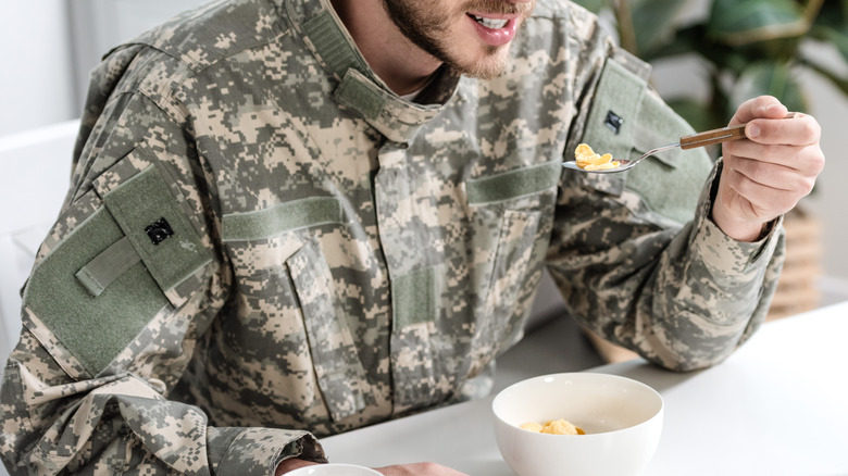 Man in a military uniform eating
