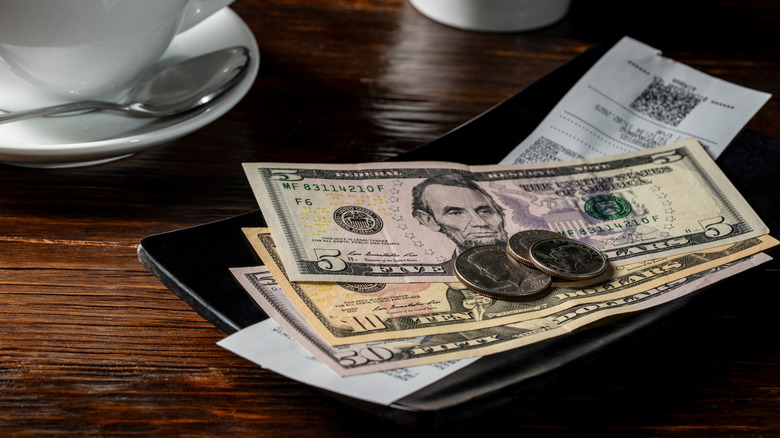 Cash and change left on top of a receipt