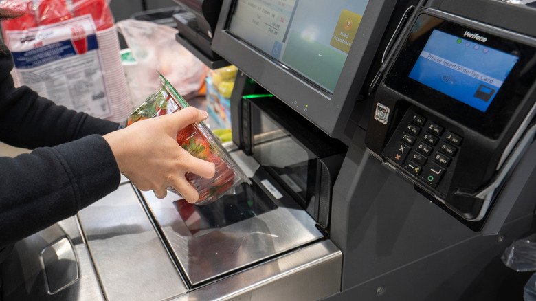 customer self checking strawberries at Costco