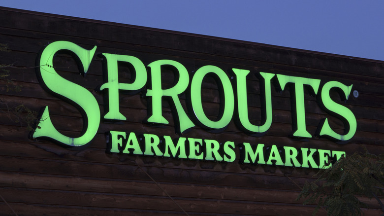 The outside of a Sprouts Farmers Market building in the dark