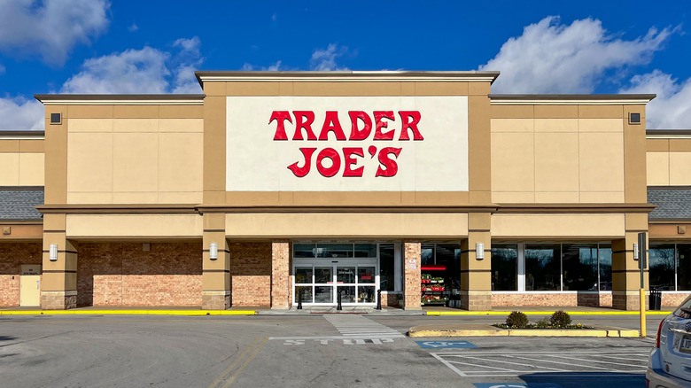 The outside of a Trader Joe's building with a bright blue sky above it