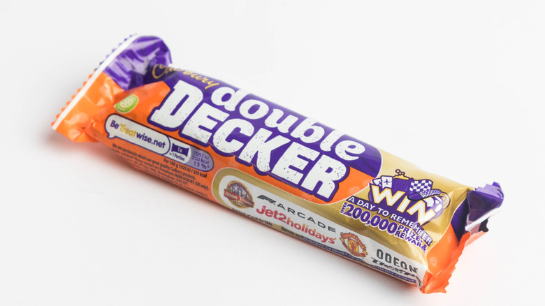 A Cadbury Double Decker bar in its wrapper on white background