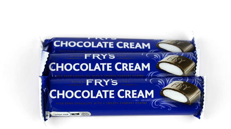 Three Fry's Chocolate Cream bars in wrappers against white background