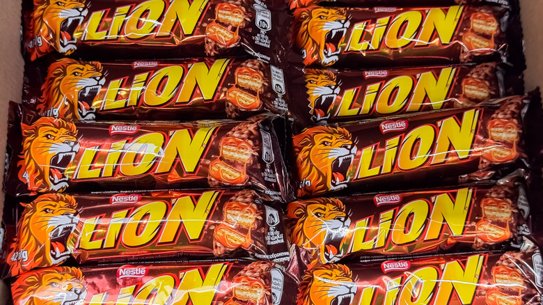 Several Nestlé Lion bars in wrappers in two rows