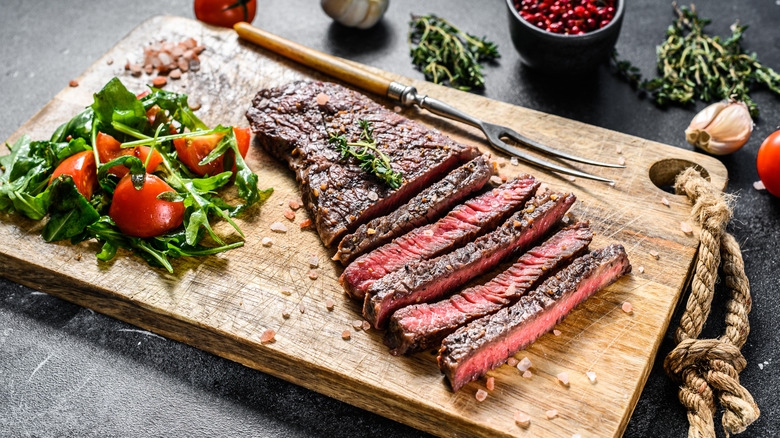 grilled and sliced denver steak on a cutting board