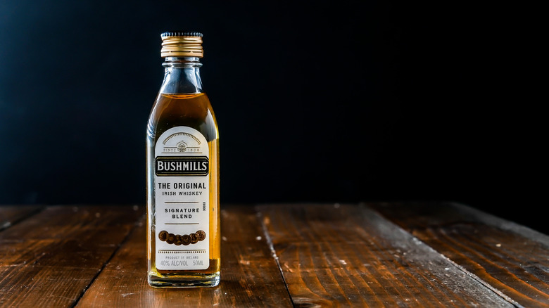 Bottle of Bushmills on wooden table