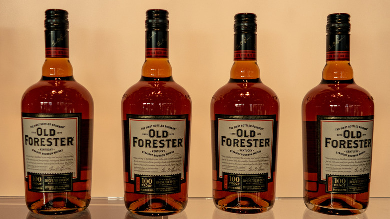 Four bottles of Old Forester whiskey