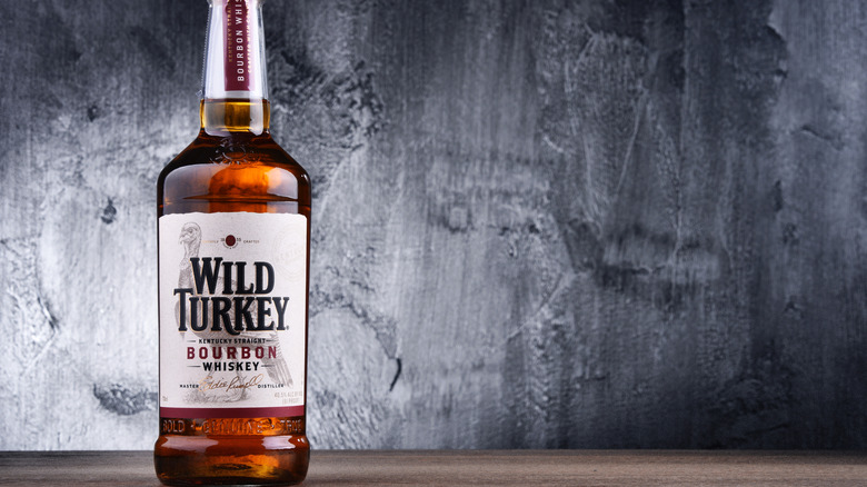 Bottle of Wild Turkey bourbon against concrete wall background