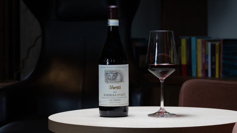 Vietti wine bottle and glass on a white table
