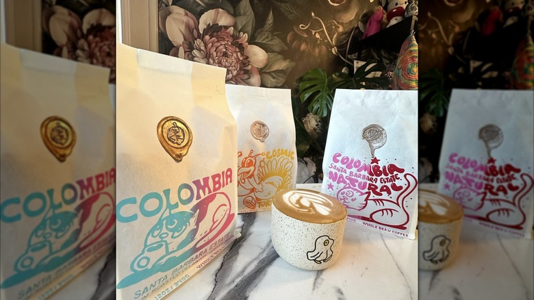 Bags of Brandywine Coffee Roasters and a flat white in a cup