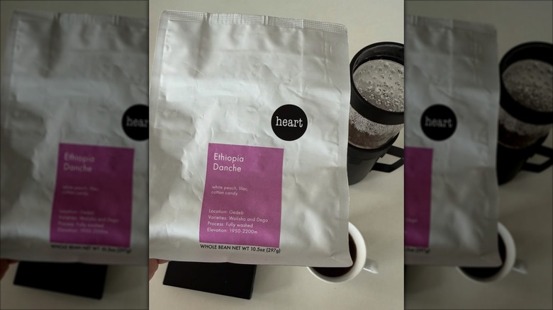 Bag of Heart Coffee Roasters beans alongside brewing equipment