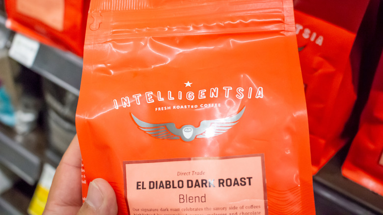 Hand holding bag of Intelligentsia coffee