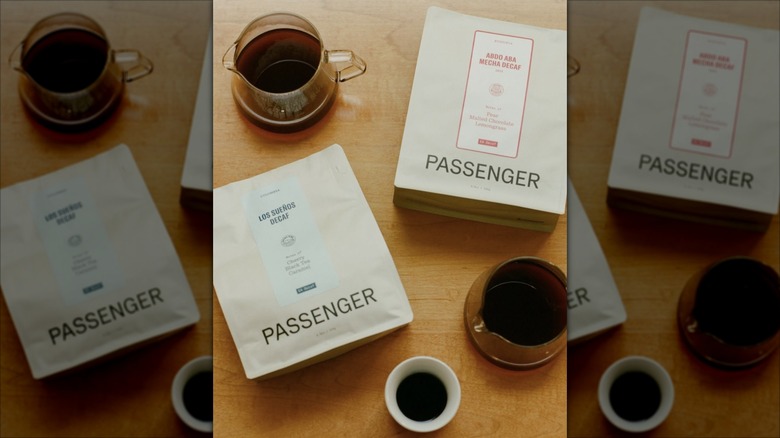 Bags of Passenger coffee beans and jugs of brewed coffee