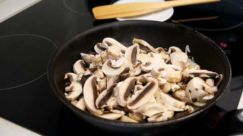 Mushrooms in skillet on induction stove
