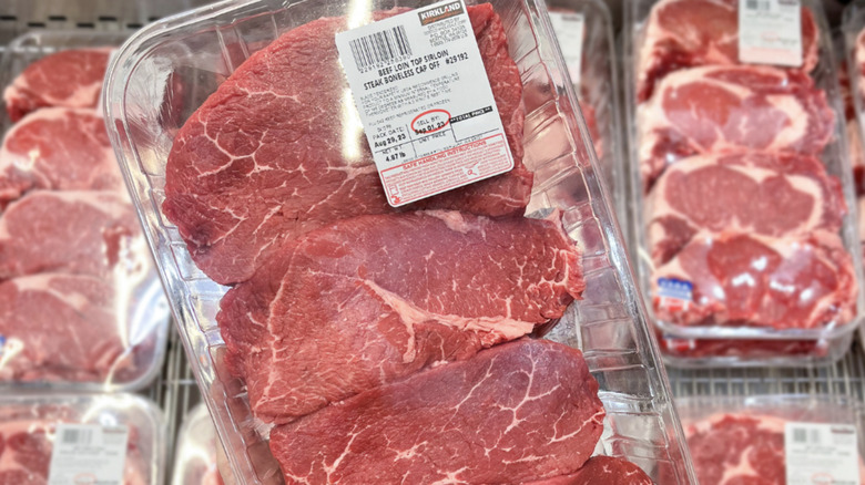 Plastic container of raw sirloin steaks