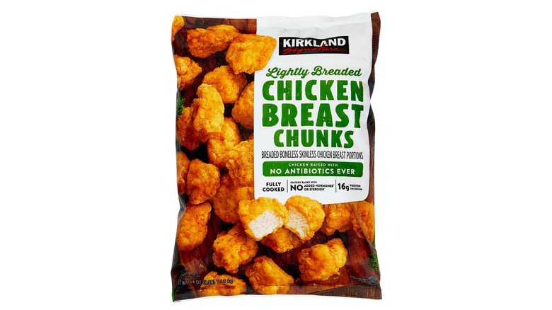 Product image of bag of Kirkland Signature frozen lightly breaded chicken breast chunks on a white background