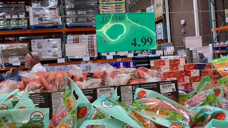 Bags of apples at Costco and a $4.99 sign