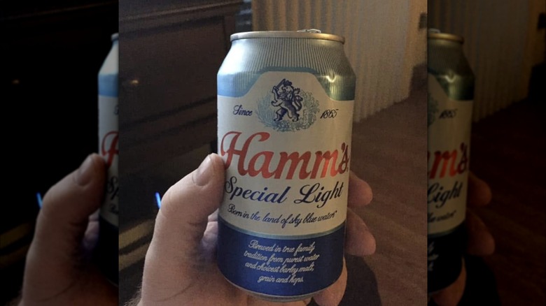 Hand holding can of Hamm's Special Light