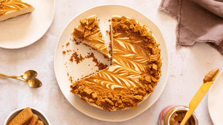 Whole biscoff cookie butter cheesecake with slices removed