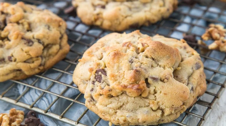 Large chocolate chip cookies cooling on wire rack